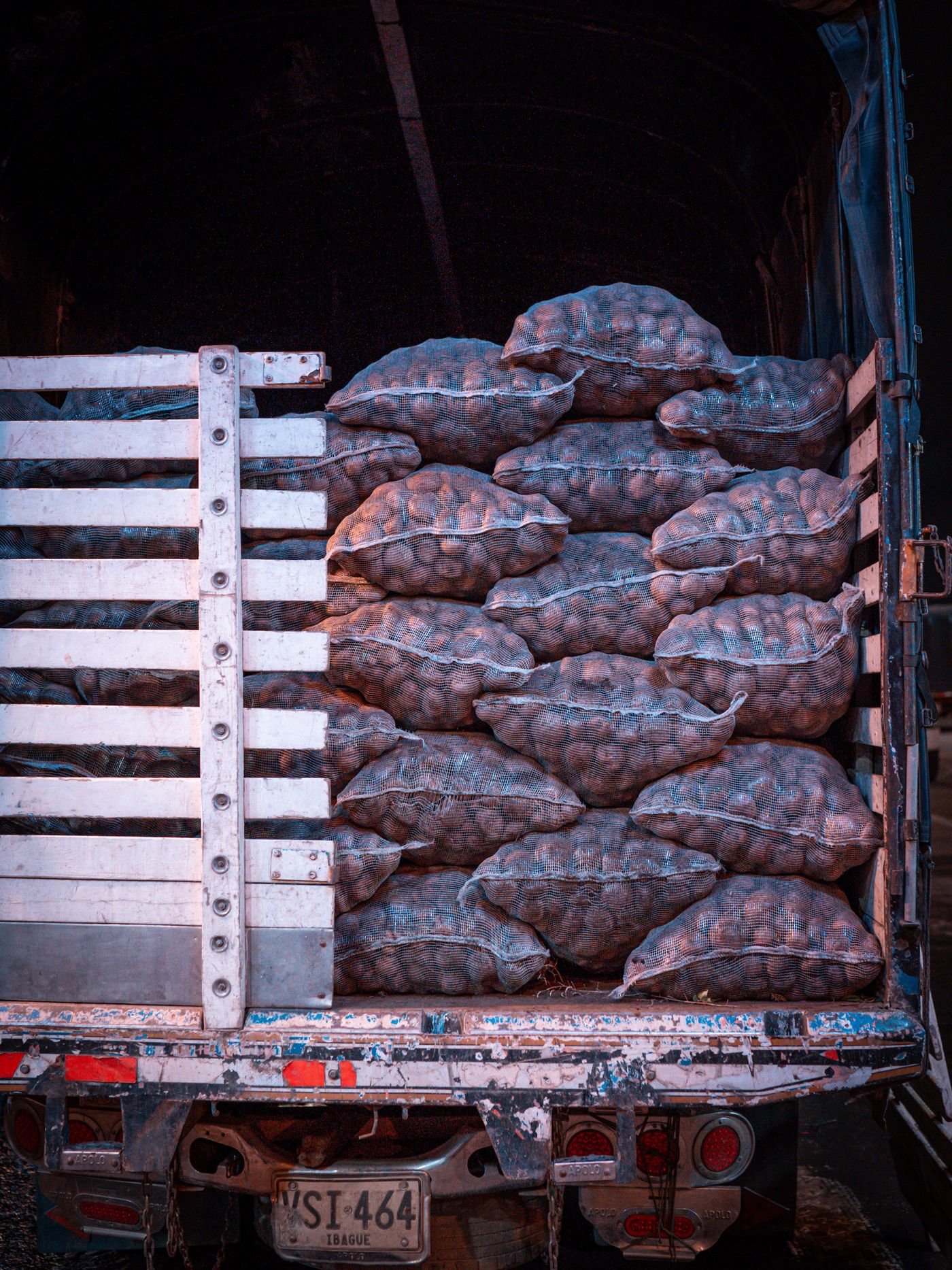 A truck loaded with sacks of potatoes, ready to leave for market